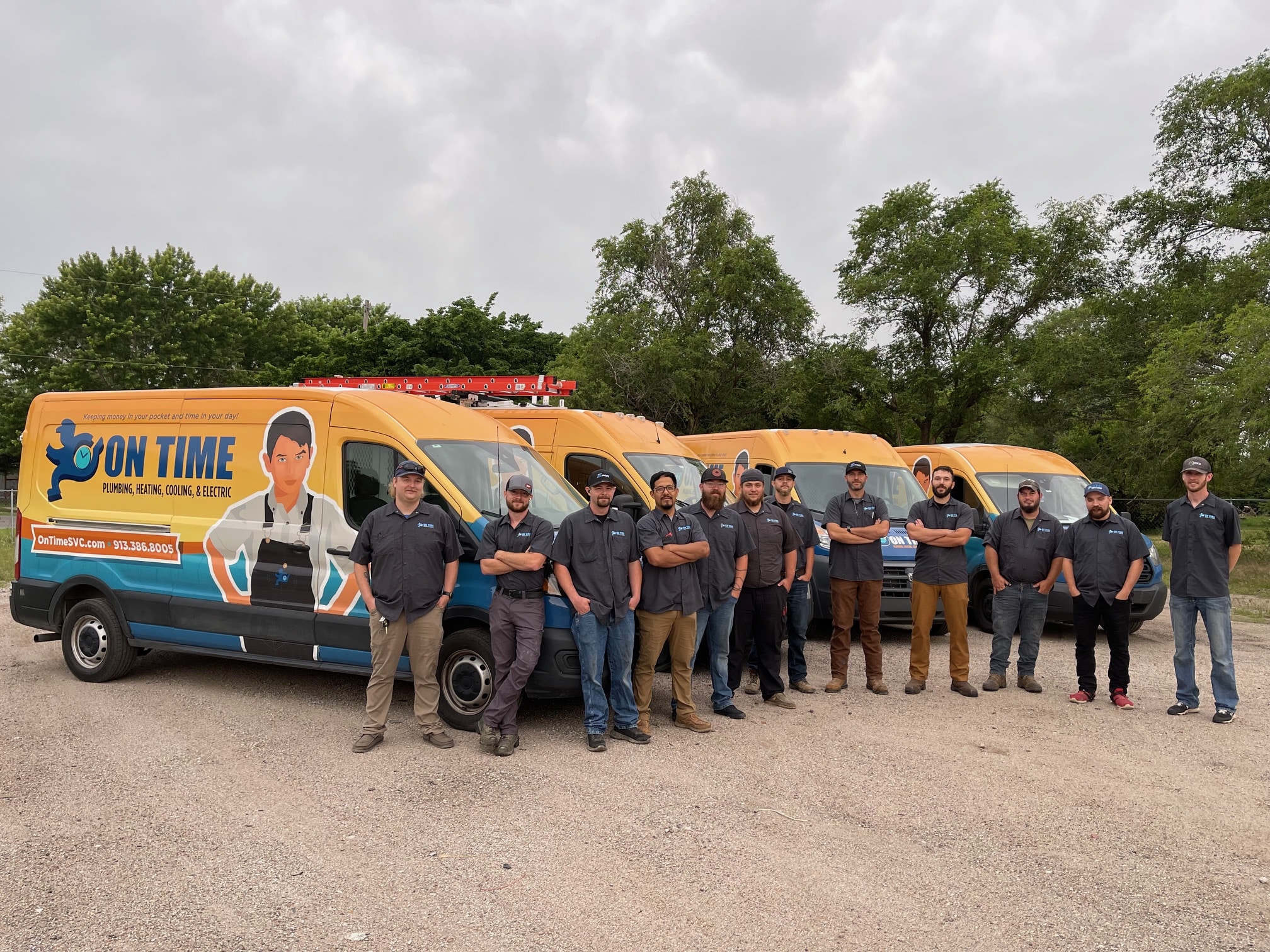 On Time Heating, Cooling, Plumbing & Electrical Technicians in front of trucks.